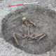 A female skeleton found at the site with hands bound and feet removed.